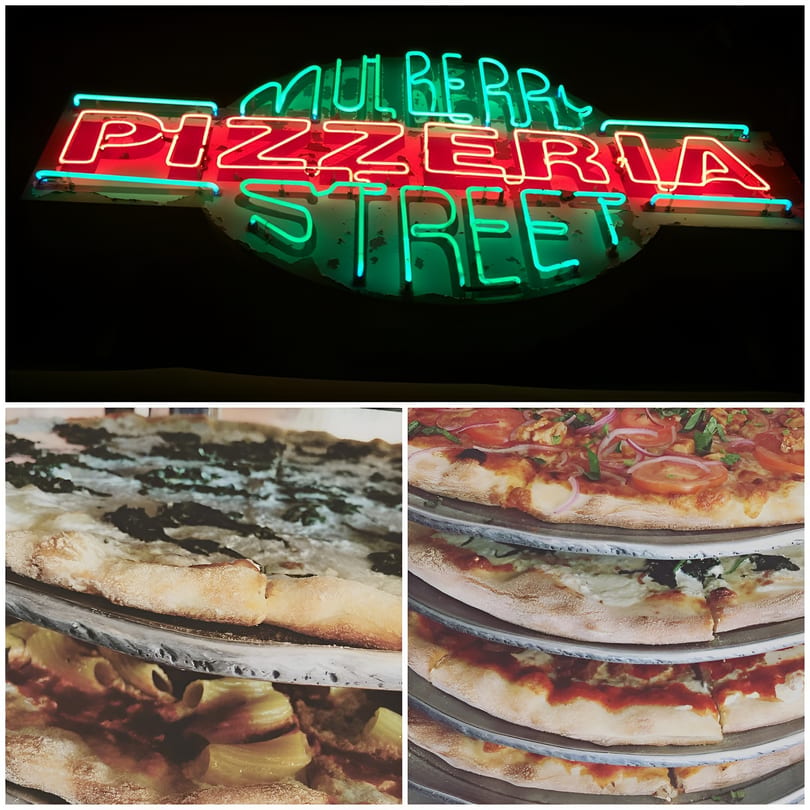 Neon sign for Mulberry Street Pizzeria, with various pizzas and pasta dishes below.